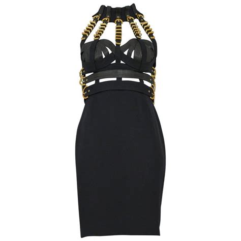 versace yellow and black dress|Versace black dress with chains.